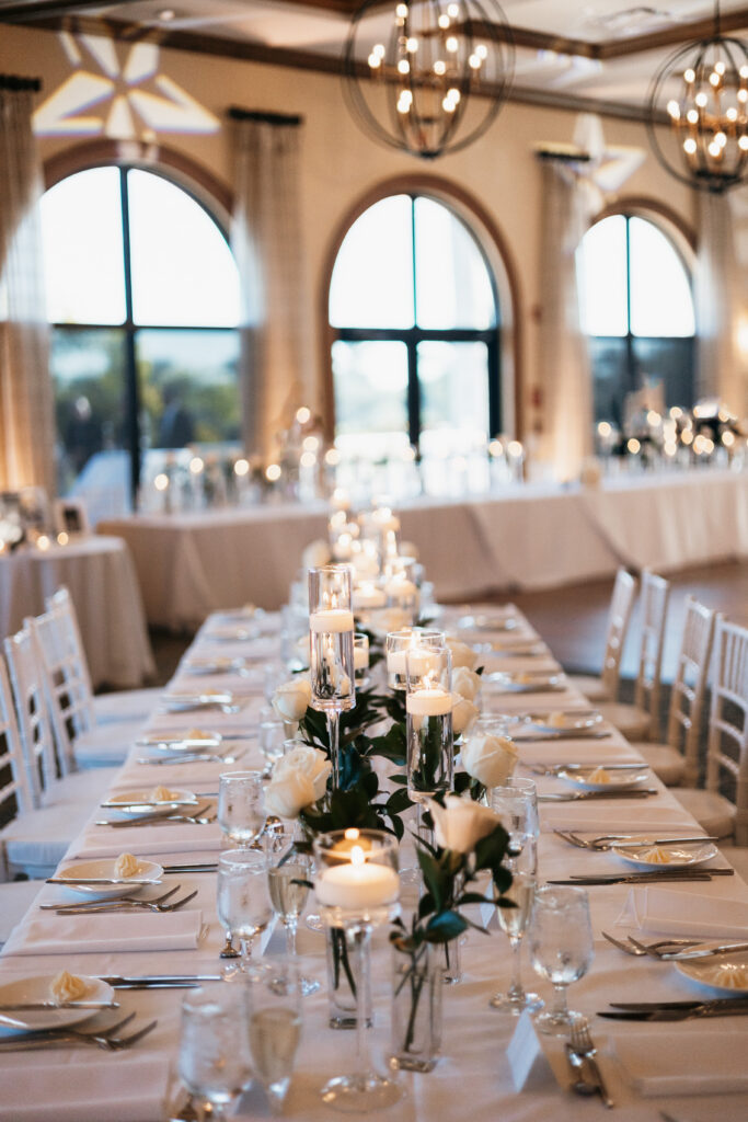 Classy wedding decor with florals, vases, and candles at a reception for a wedding at Heritage Bay Golf and Country Club in Naples, Florida. 