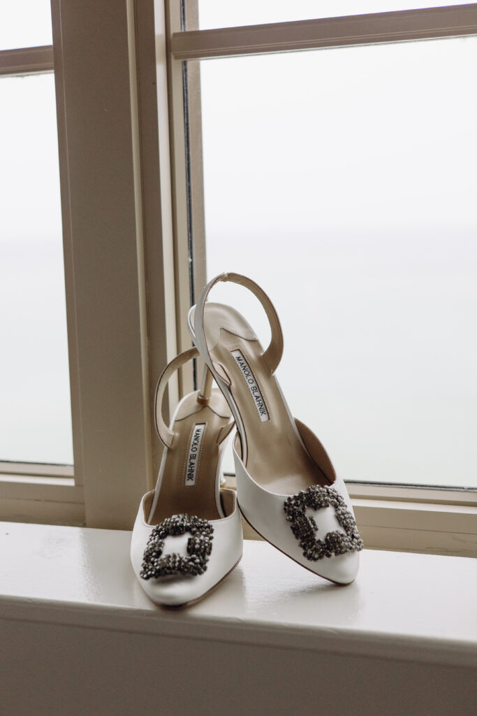 Manolo Blahnick heels framed iin front of windows at The Ritz-Carlton Resort in Naples, Florida during detail shots for a wedding. 
