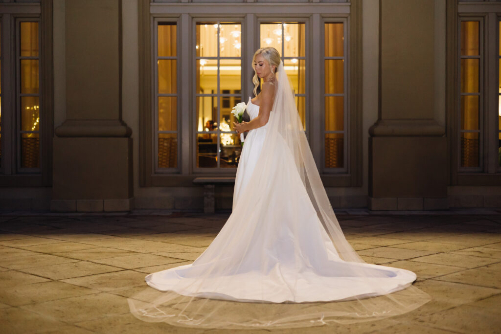Bride posing for photos during her wedding at The Ritz-Carlton Resort in Naples, Florida. 