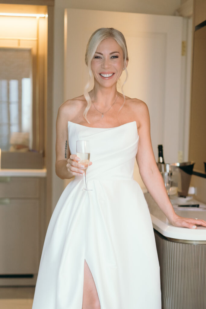 Bride posing happily for bridal portraits during her wedding at The Ritz-Carlton Resort in Naples, Florida. 