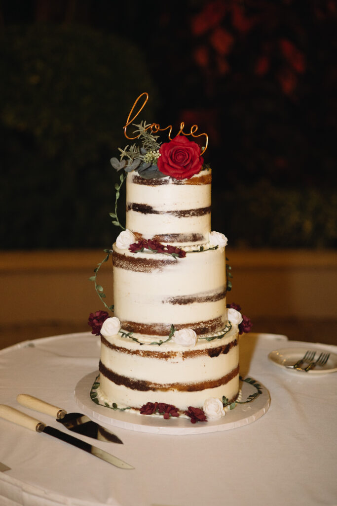 Beautiful wedding cake during wedding reception at The Club at the Strand in Naples, Florida. 