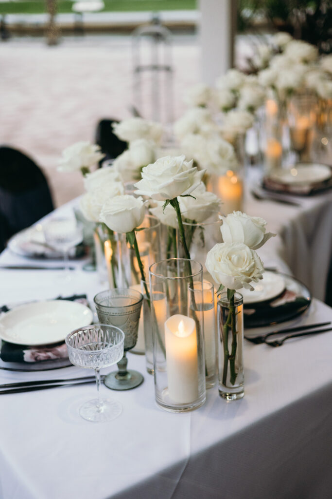 Table decor with flowers and candles at wedding reception at Naples Bay Resort in Naples, Florida. 